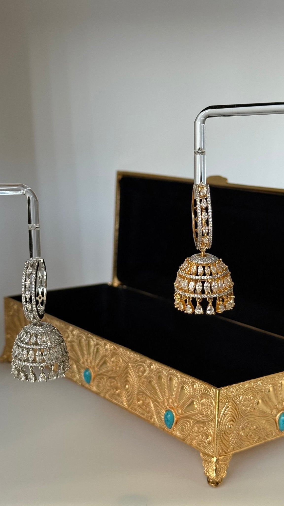 Gold-plated Sarima jhumka earrings with CZ stones
Silver rhodium Sarima jhumka earrings 
Sarima jhumka earrings styled